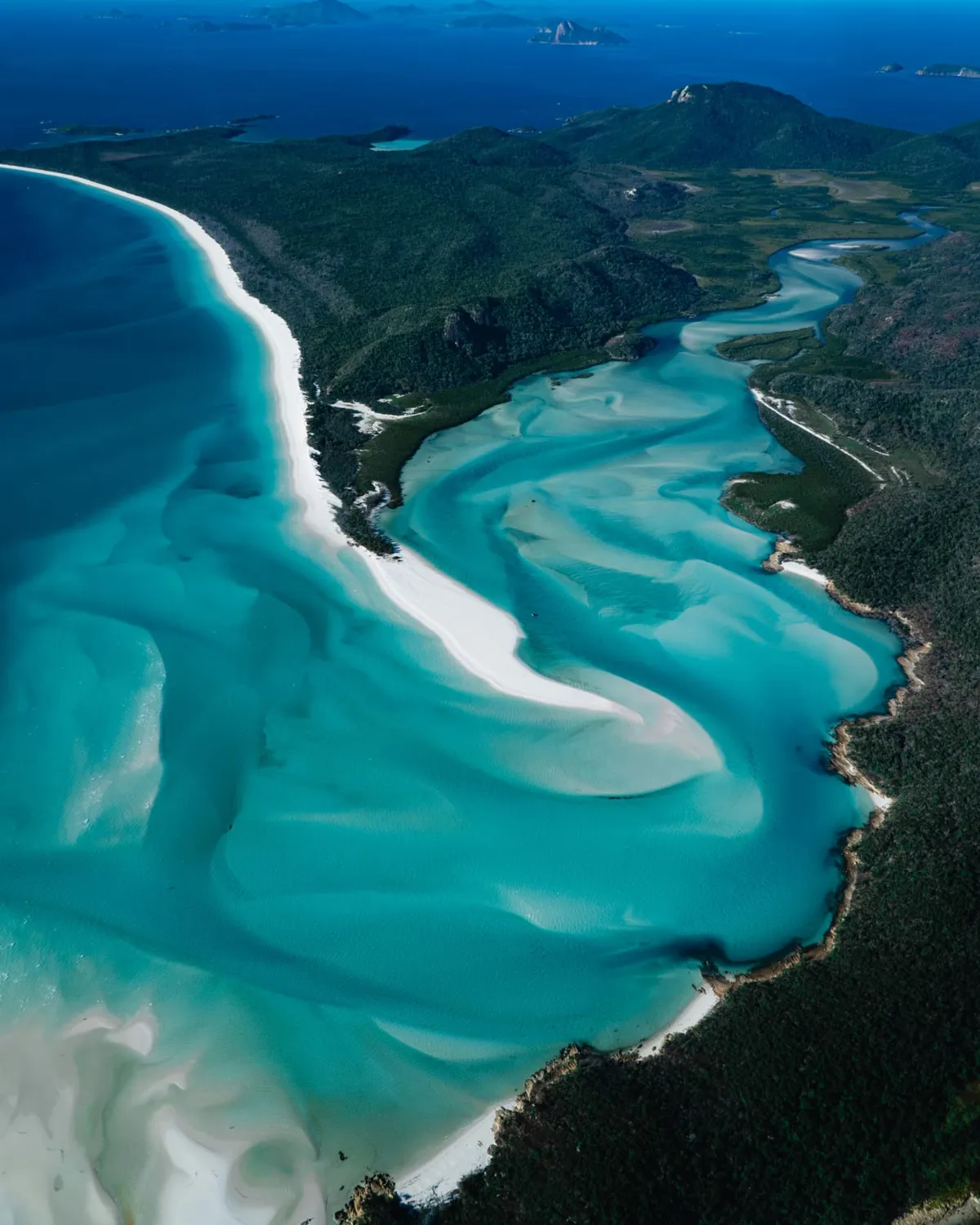 Aerial view of turquoise waters and white sand along the coast on Country